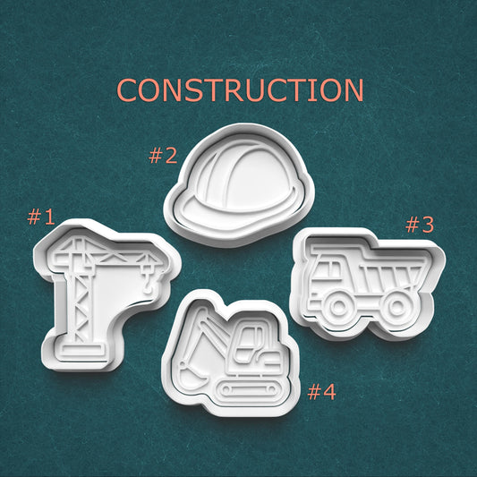 Set of construction-themed cookie cutters on a teal background with 'CONSTRUCTION' text.
